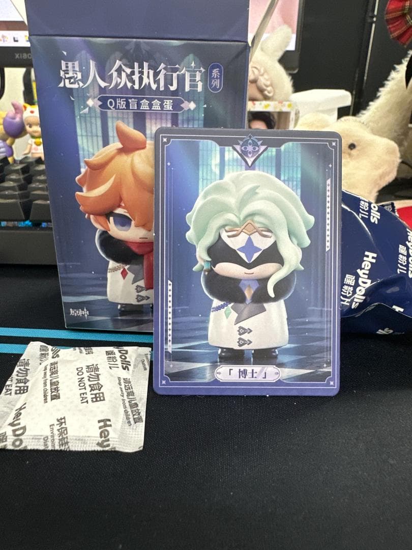 Unedited listing photo of the Dottore card in front of a blue box and inner bag
