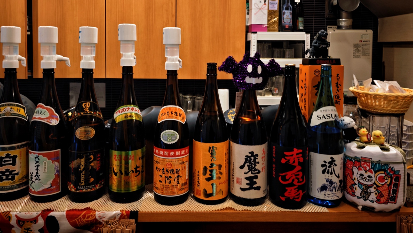 Bottles of shochu lined up inside Yakitori Senkichi