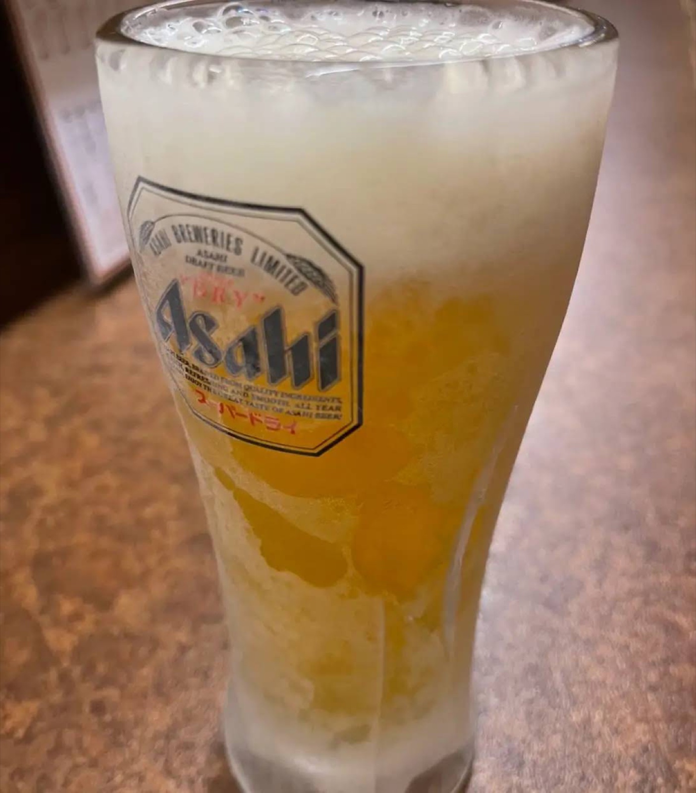 A glass of draft beer with a frosty glass