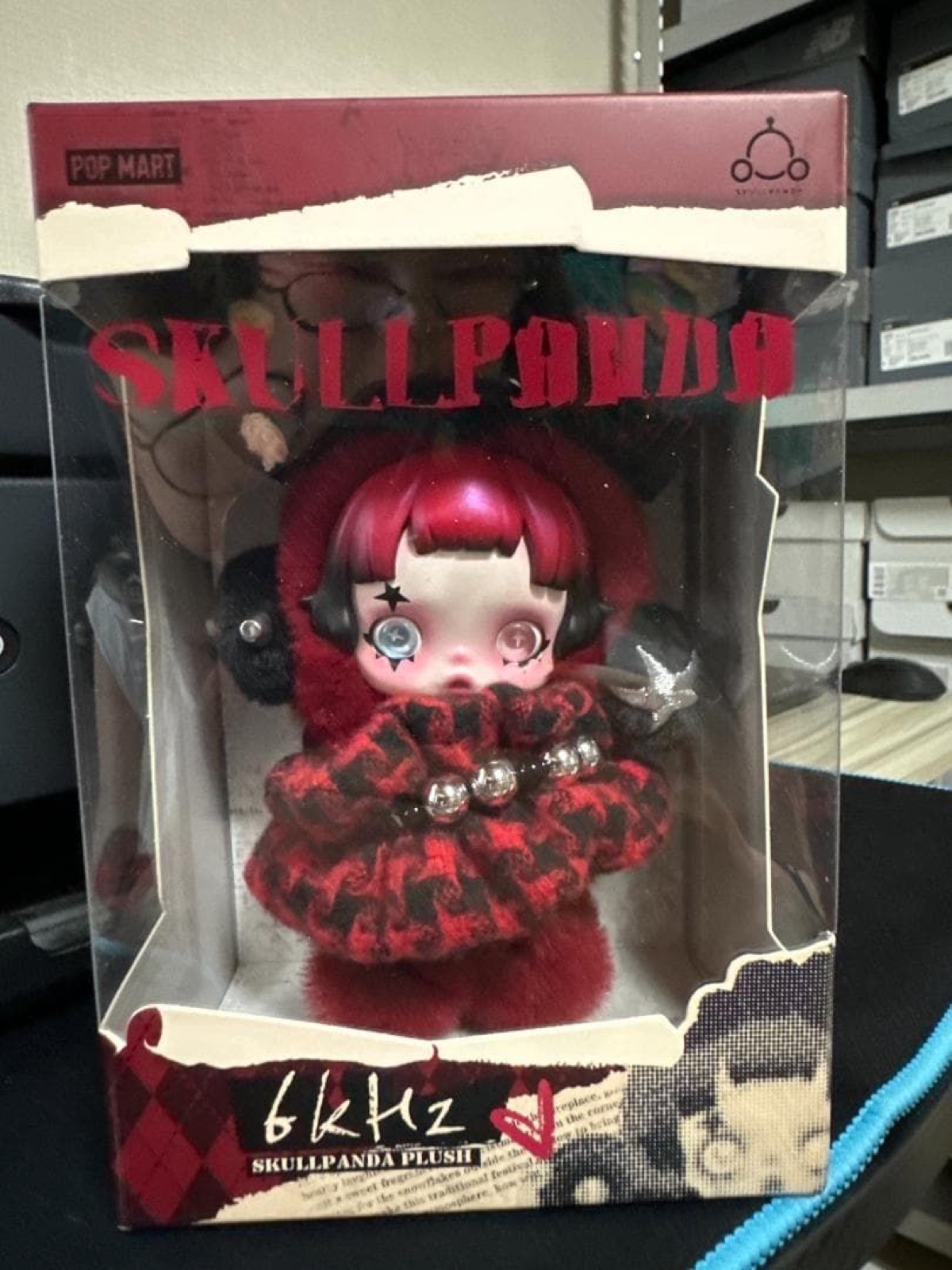 Front of the SKULLPANDA 6kHz box with the red-haired plush visible through the window (unedited photo)