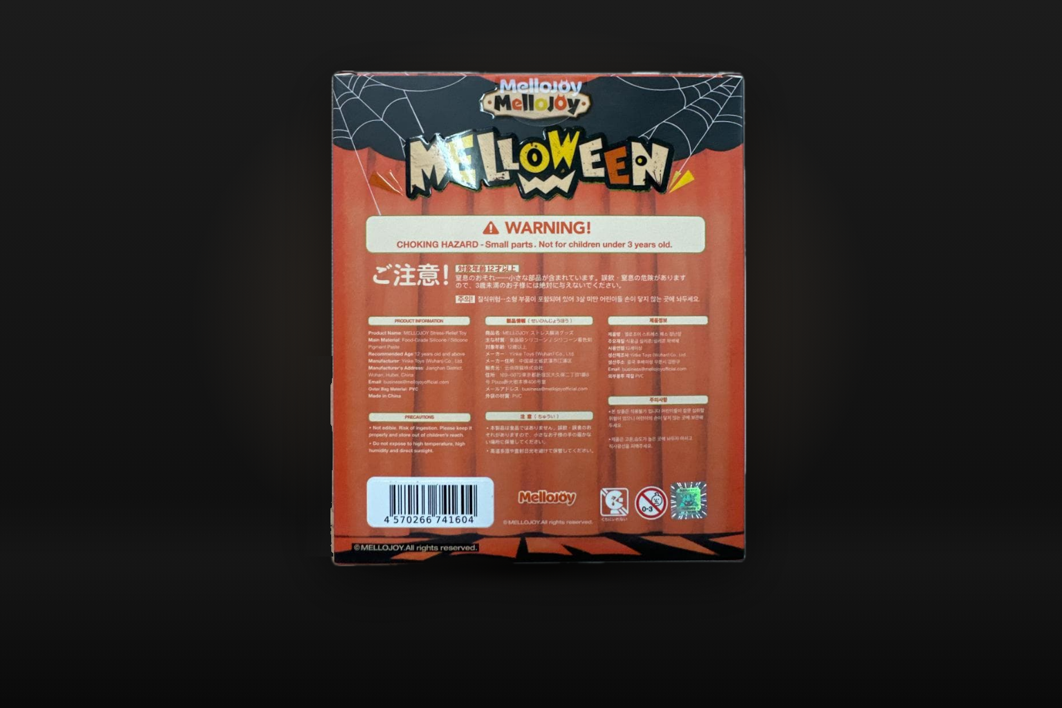 Against a dark grey backdrop, the back of an orange Mellojoy MELLOWEEN box with warnings, product information in three languages and a barcode