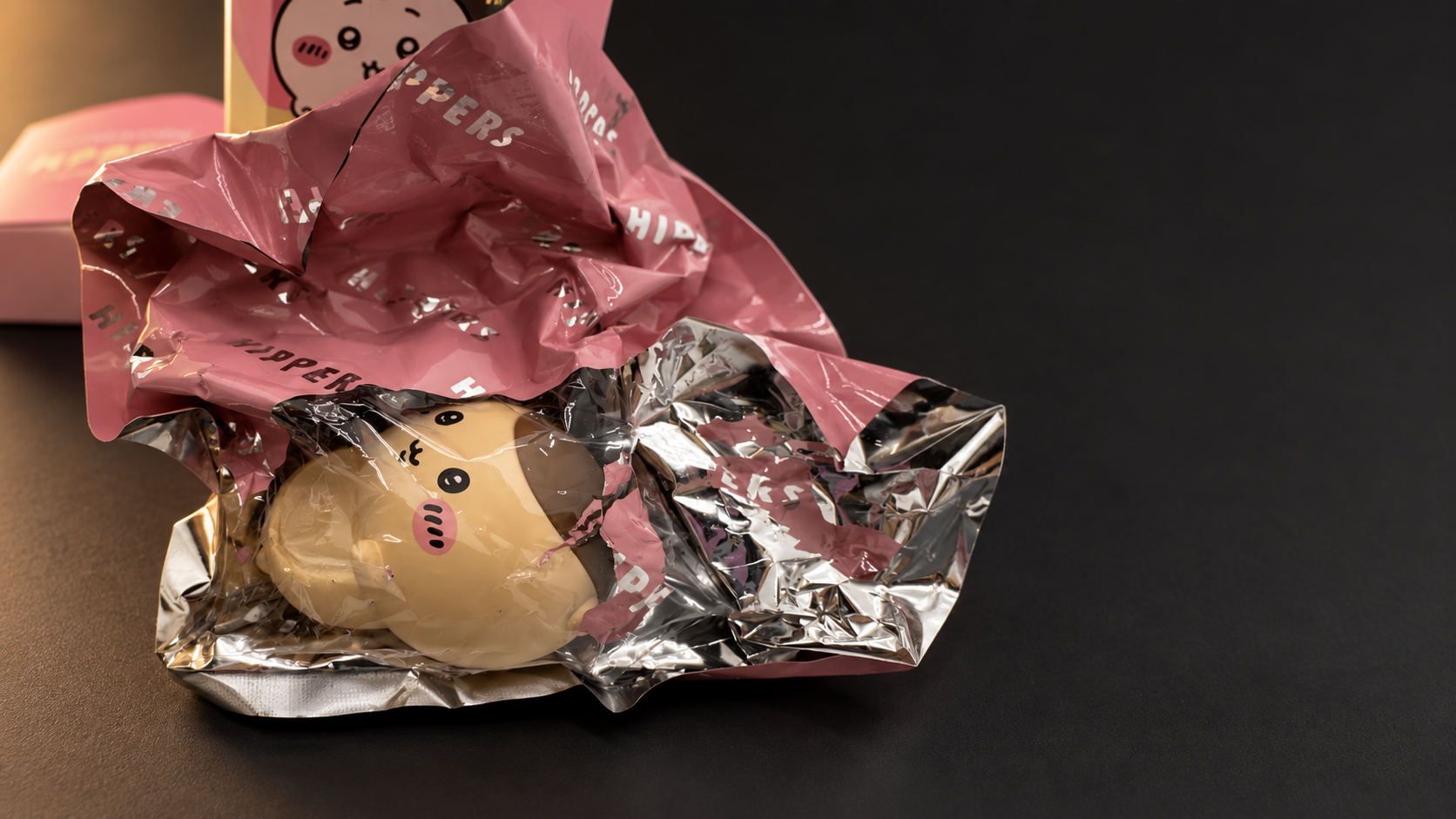 An edited close-up of Kurimanju HIPPERS in opened pink and silver packaging