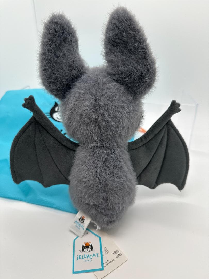 Unedited rear view of the grey bat plush, including wings and tags