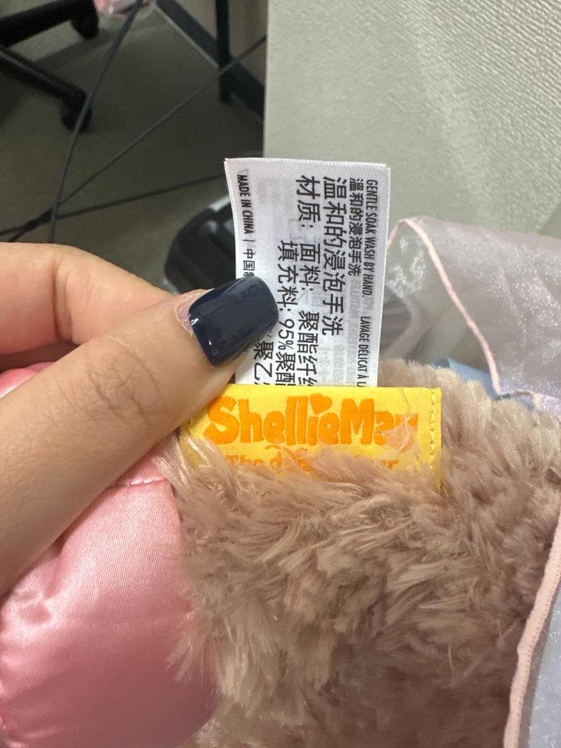 Unedited seller photo of the plush's fabric labels and Shanghai Disney tag